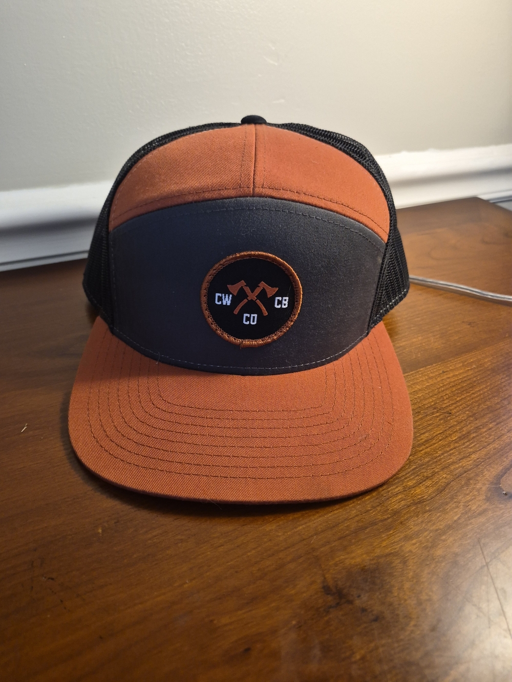 CRESTED BUTTE CO. Rust and Charcoal Patch Trucker Hat with Crossed Axe Logo